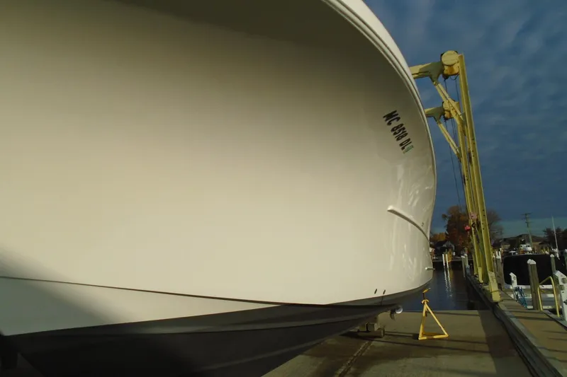 Slide: The Image of 2006 Buddy Davis 34 Center Console boat on a lift at a marina. - 18