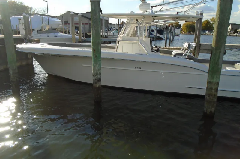 Slide: The Image of 2006 Buddy Davis 34 Center Console boat docked at marina, side view. - 2