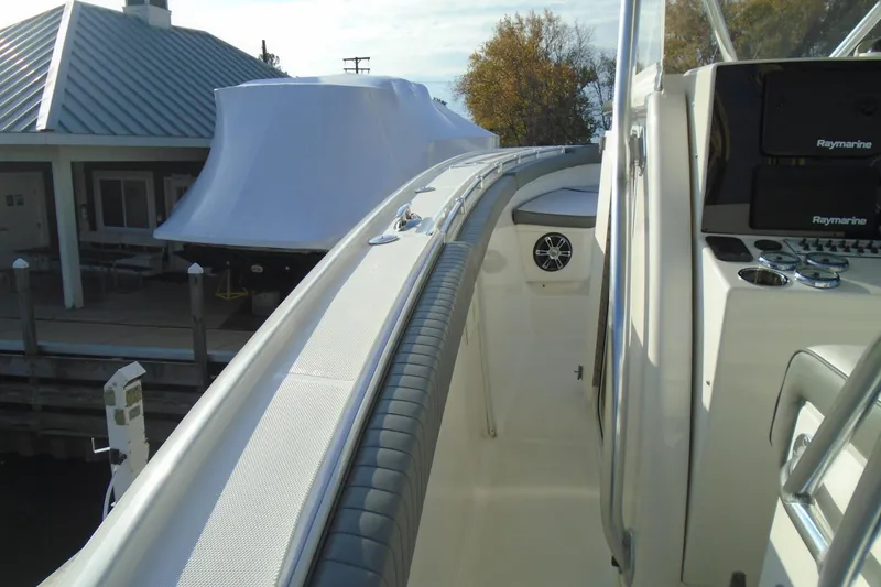 Slide: The Image of 2006 Buddy Davis 34 Center Console boat docked, featuring sleek design and modern equipment. - 24