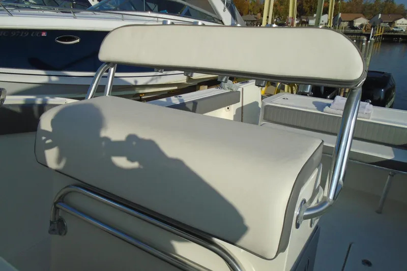 Slide: The Image of 2006 Buddy Davis 34 Center Console boat with cushioned seating and stainless steel frame. - 27