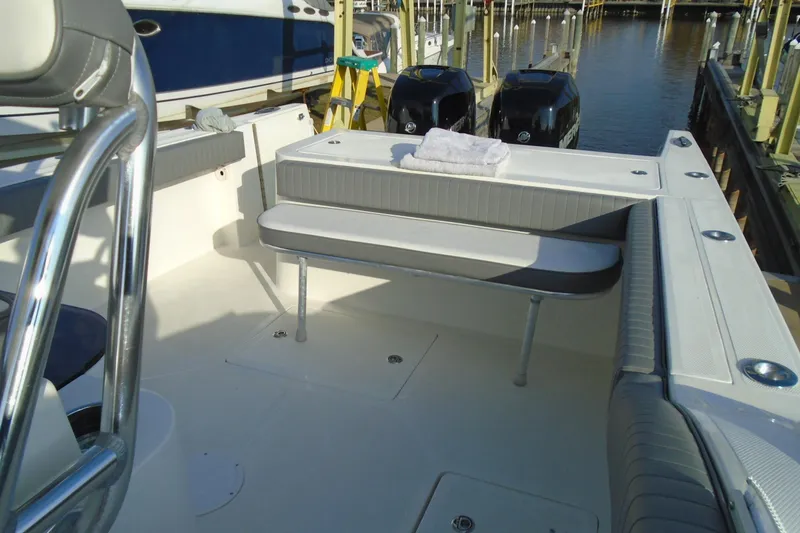 Slide: The Image of 2006 Buddy Davis 34 Center Console boat interior with seating and twin engines at dock. - 28