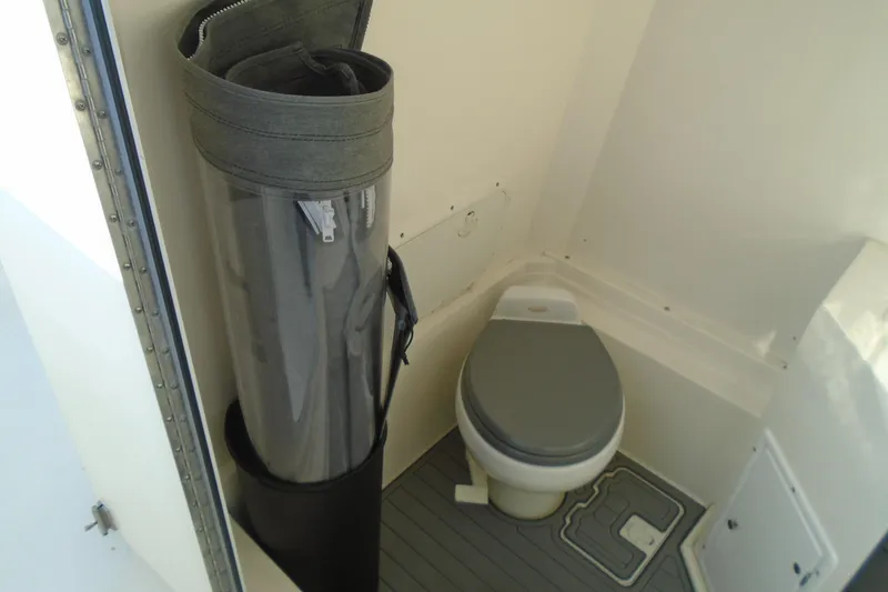 Slide: The Image of 2006 Buddy Davis 34 Center Console boat bathroom with toilet and storage. - 29