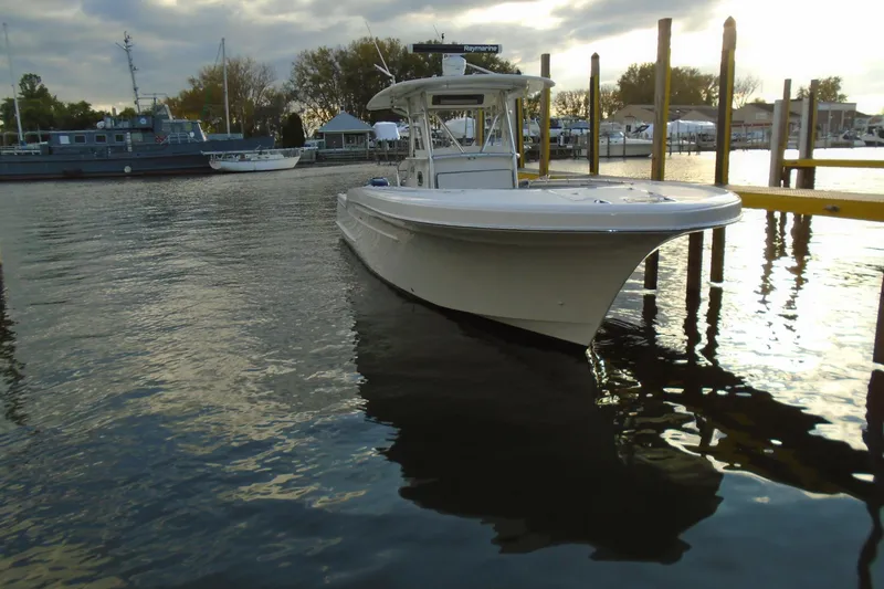 Slide: The Image of 2006 Buddy Davis 34 Center Console boat docked in a serene marina setting. - 3