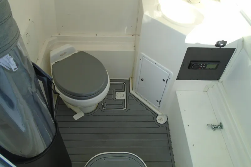Slide: The Image of 2006 Buddy Davis 34 Center Console boat bathroom with toilet and control panel. - 30