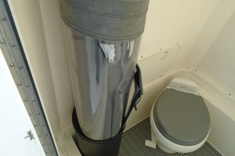 Slide: The Image of 2006 Buddy Davis 34 Center Console boat interior with toilet and storage compartment. - 32