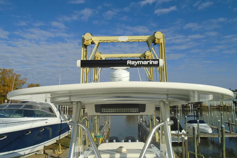 Slide: The Image of 2006 Buddy Davis 34 Center Console with Raymarine equipment at a marina under a blue sky. - 36