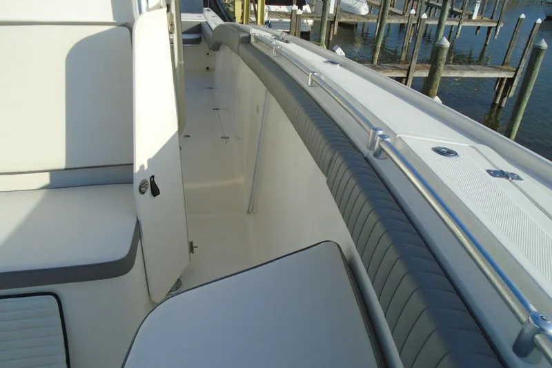 Slide: The Image of 2006 Buddy Davis 34 Center Console boat interior with seating and storage, dockside view. - 37