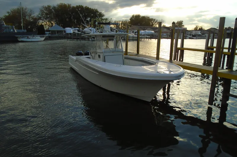 Slide: The Image of 2006 Buddy Davis 34 Center Console boat docked at sunset, calm waters. - 4