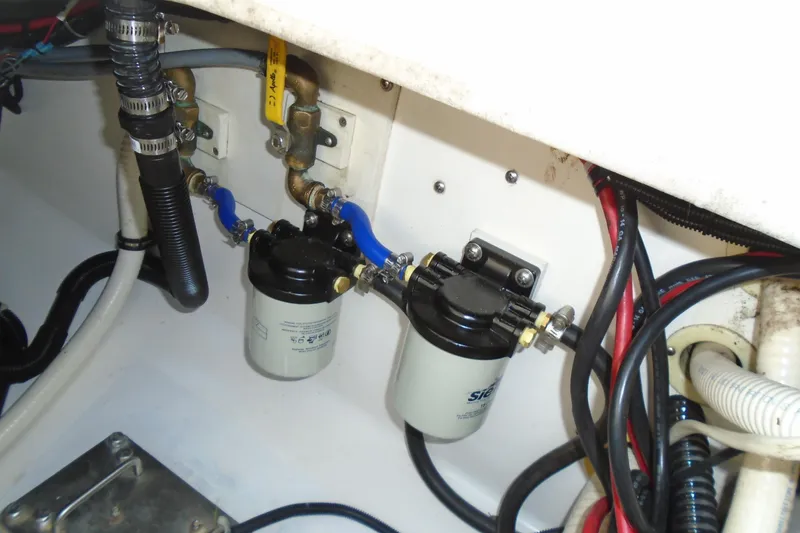 Slide: The Image of Engine compartment of 2006 Buddy Davis 34 Center Console with fuel filters and hoses. - 46