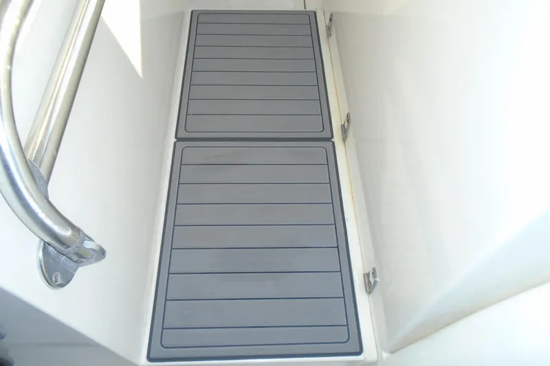 Slide: The Image of 2006 Buddy Davis 34 Center Console boat deck with non-slip flooring and metal railing. - 52