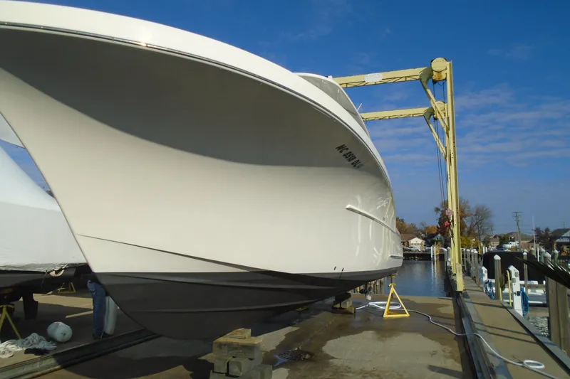 Slide: The Image of 2006 Buddy Davis 34 Center Console boat on lift at marina. - 54