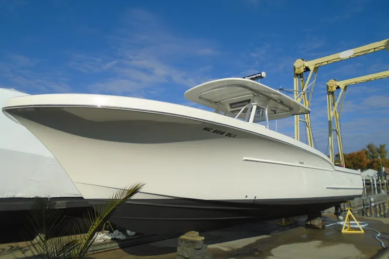 Slide: The Image of 2006 Buddy Davis 34 Center Console boat on dry dock under clear blue sky. - 55