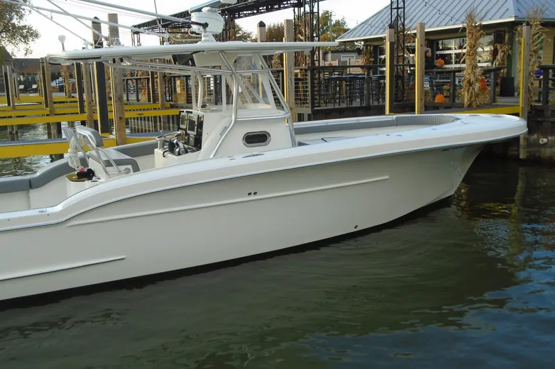 Slide: The Image of 2006 Buddy Davis 34 Center Console boat docked at marina. - 6
