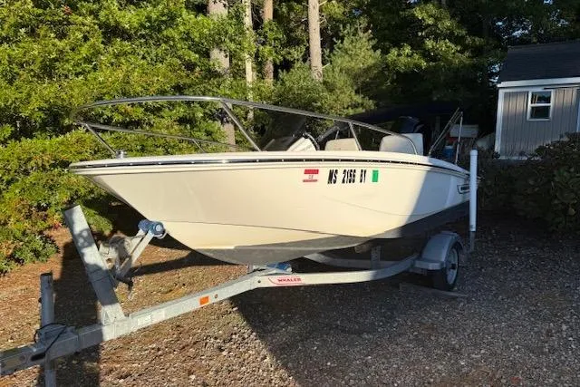 The Image of 2021 Boston Whaler 130 Super Sport boat on trailer, parked outdoors. - 0