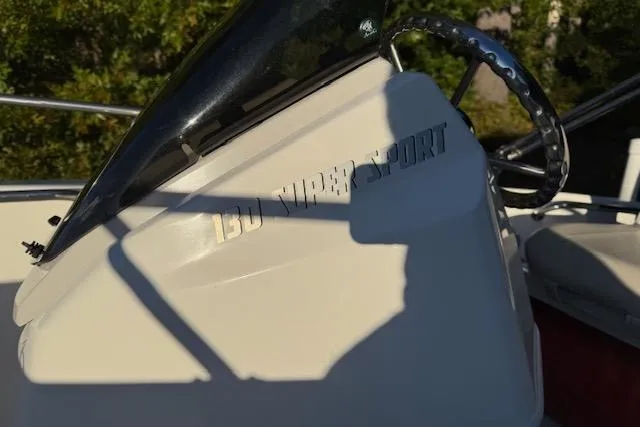 Slide: The Image of 2021 Boston Whaler 130 Super Sport boat console with steering wheel detail. - 10