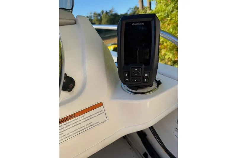 Slide: The Image of Garmin device on 2021 Boston Whaler 130 Super Sport boat dashboard. - 12