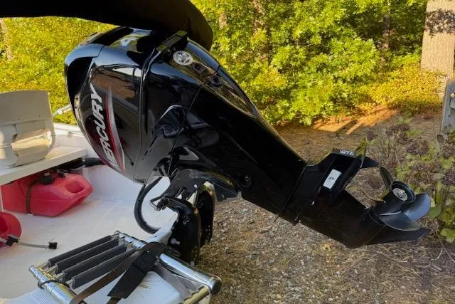 Slide: The Image of 2021 Boston Whaler 130 Super Sport with Mercury outboard motor, parked outdoors. - 4