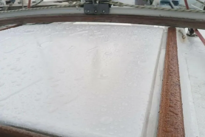 Slide: The Image of Close-up of a wet deck on a 1984 Beneteau First 38.5 sailboat. - 18