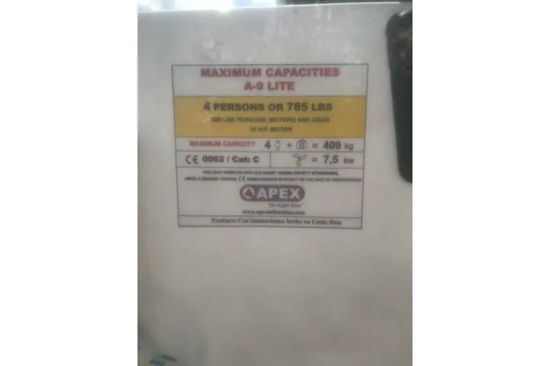 Slide: The Image of Capacity label on Beneteau First 38.5, 1984, showing weight and person limits. - 24