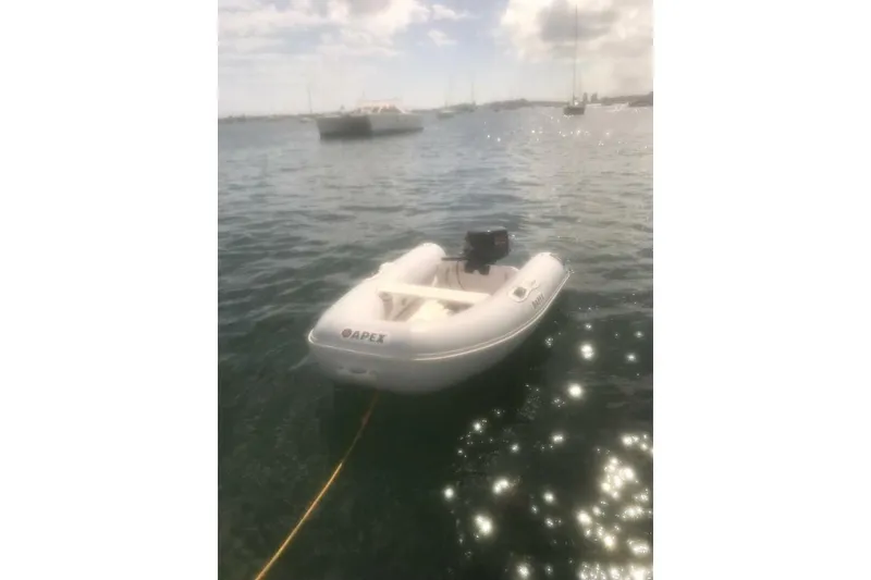 Slide: The Image of Inflatable boat on water near Beneteau First 38.5, 1984 model, under sunny sky. - 4