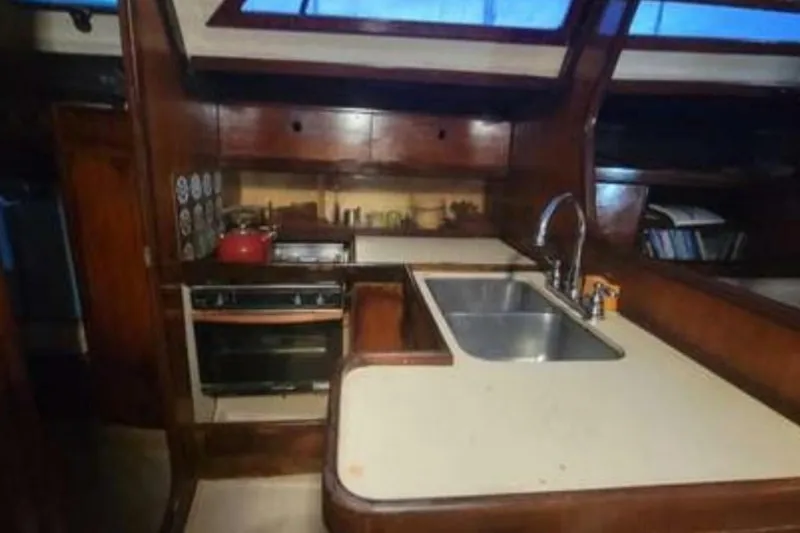 Slide: The Image of Interior of 1984 Beneteau First 38.5 sailboat kitchen with stove and sink. - 7