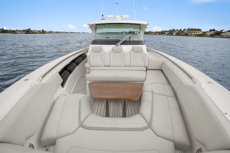 Slide: The Image of Luxurious 2022 Tiara Sport 43 LS boat interior with plush seating and wooden table. - 11