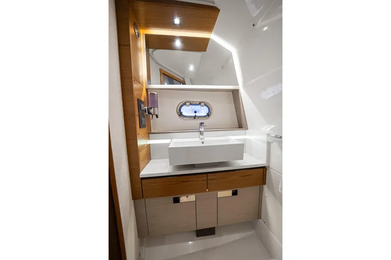 Slide: The Image of Luxurious 2022 Tiara Sport 43 LS yacht bathroom with modern sink and elegant wood accents. - 20
