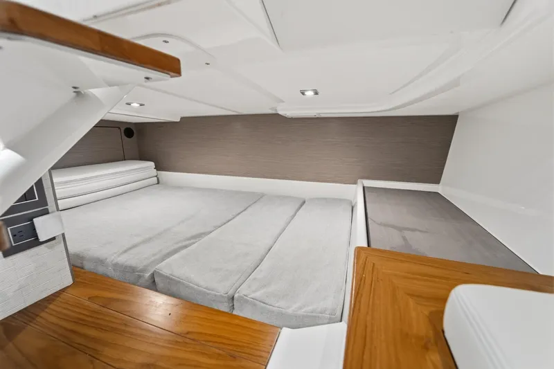 Slide: The Image of 2022 Tiara Sport 43 LS cabin interior with modern design and comfortable bedding. - 22
