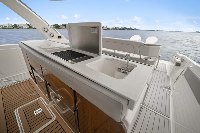 Slide: The Image of Luxurious 2022 Tiara Sport 43 LS yacht with outdoor kitchen and scenic water view. - 26