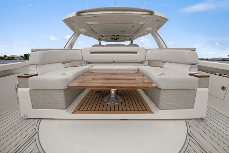 Slide: The Image of 2022 Tiara Sport 43 LS yacht interior with luxurious seating and wooden table. - 28