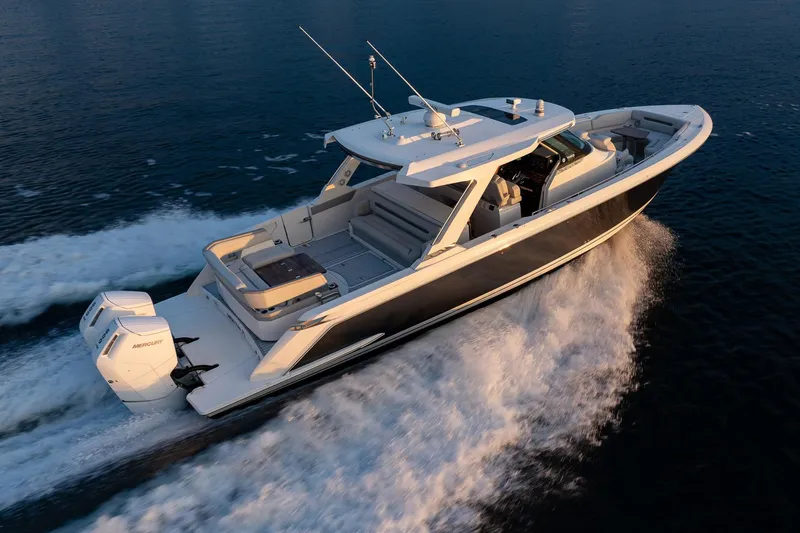 Slide: The Image of 2022 Tiara Sport 43 LS luxury boat cruising on open water. - 3