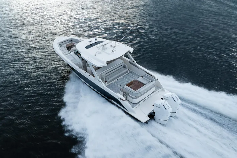 Slide: The Image of 2022 Tiara Sport 43 LS boat cruising on open water, aerial view. - 31