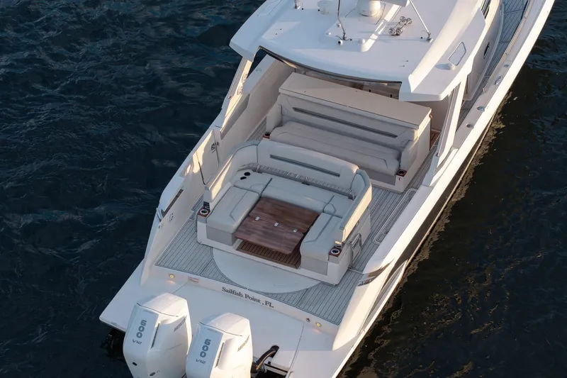 Slide: The Image of 2022 Tiara Sport 43 LS luxury yacht with spacious deck and seating, cruising on water. - 5