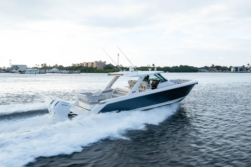 Slide: The Image of 2022 Tiara Sport 43 LS boat cruising on a scenic waterway. - 7
