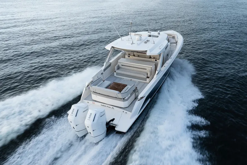 Slide: The Image of 2022 Tiara Sport 43 LS boat cruising on open water, rear view. - 8
