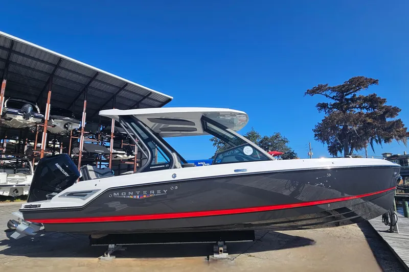 Slide: The Image of 2026 Monterey Elite 27 OB boat docked under clear blue sky. - 1