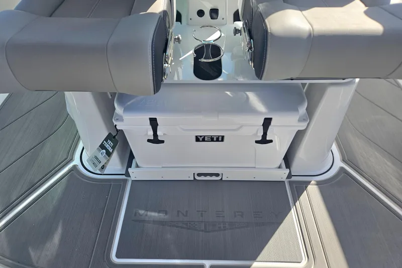 Slide: The Image of 2026 Monterey Elite 27 OB boat interior with Yeti cooler and cushioned seating. - 12