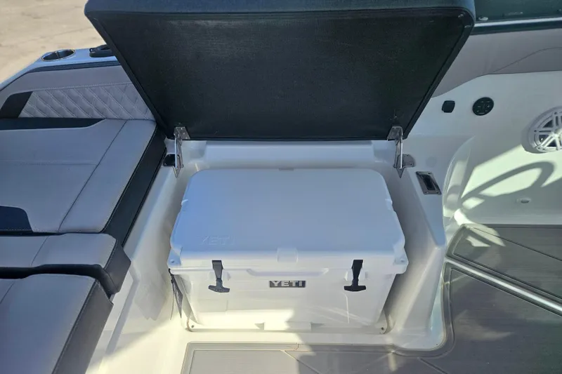 Slide: The Image of 2026 Monterey Elite 27 OB boat interior with Yeti cooler storage compartment. - 14