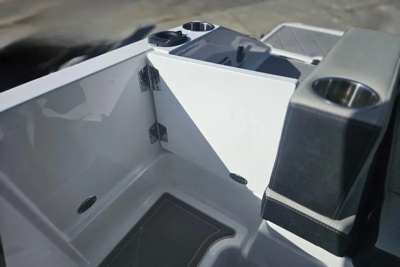 Slide: The Image of Interior view of 2026 Monterey Elite 27 OB boat, featuring cup holders and sleek design. - 17