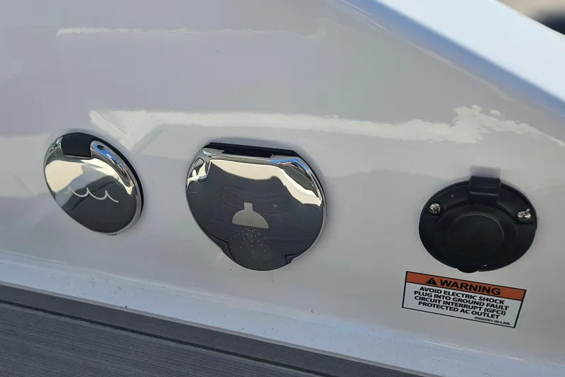 Slide: The Image of Close-up of 2026 Monterey Elite 27 OB boat fittings and warning label. - 18