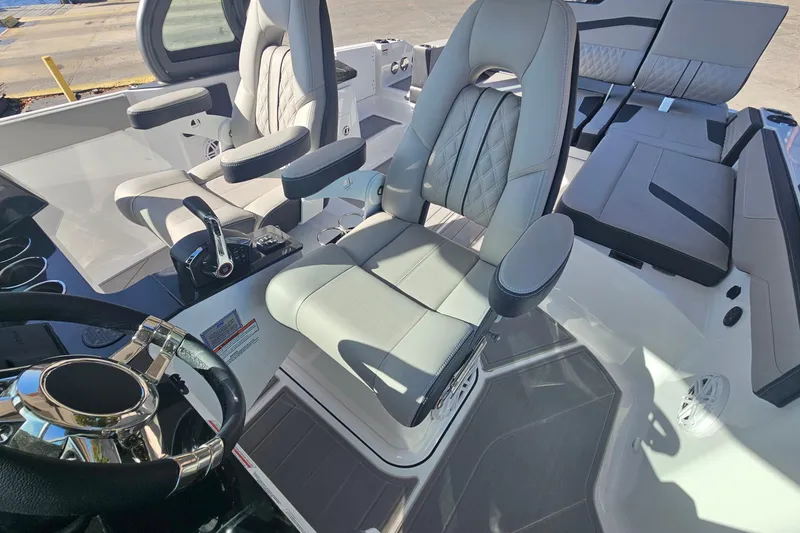 Slide: The Image of Luxury interior of 2026 Monterey Elite 27 OB boat with plush seating and modern controls. - 19