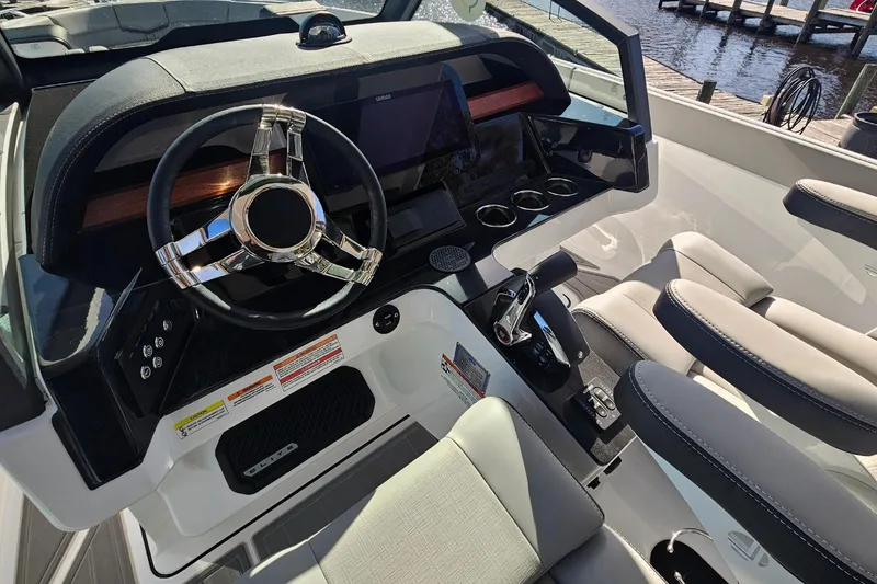 Slide: The Image of 2026 Monterey Elite 27 OB boat cockpit with modern steering and controls. - 20