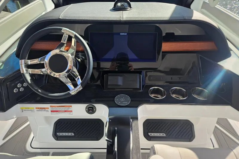 Slide: The Image of 2026 Monterey Elite 27 OB boat dashboard with modern steering and digital display. - 21