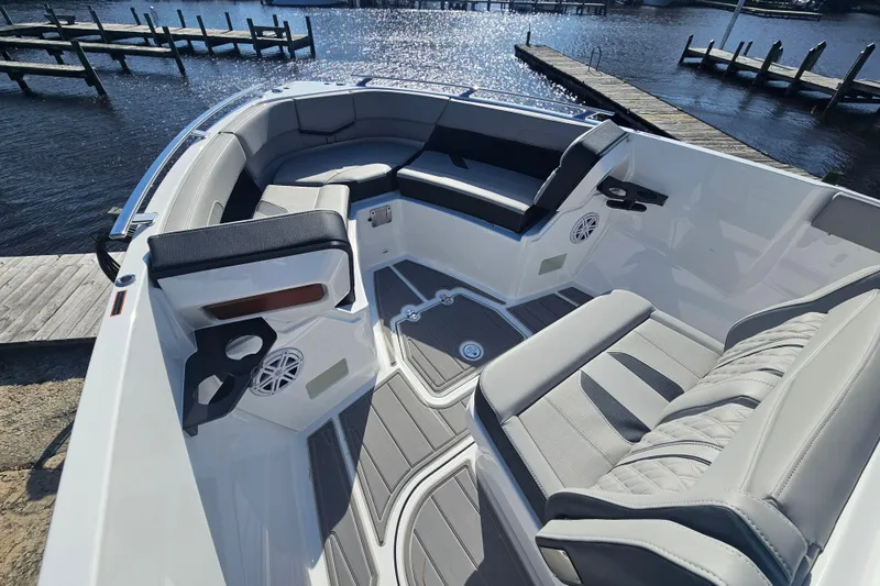 Slide: The Image of 2026 Monterey Elite 27 OB boat interior with luxurious seating and waterfront view. - 22