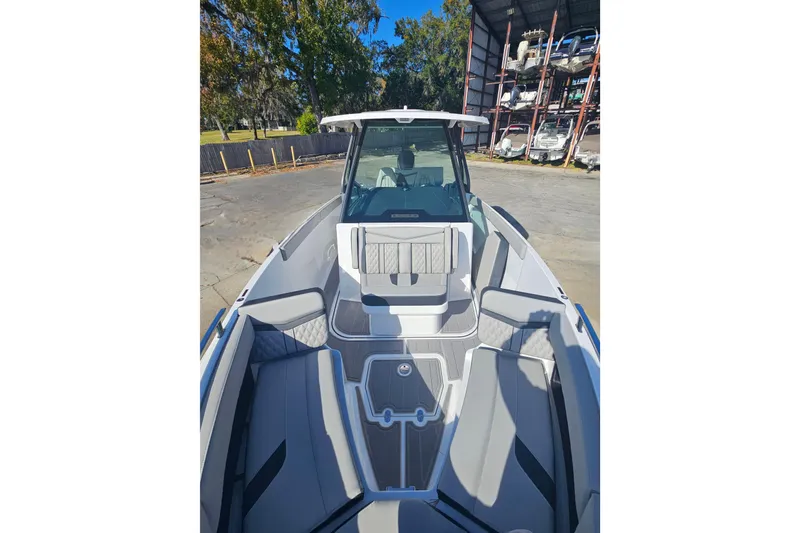 Slide: The Image of 2026 Monterey Elite 27 OB boat with sleek seating and modern design in a storage area. - 25