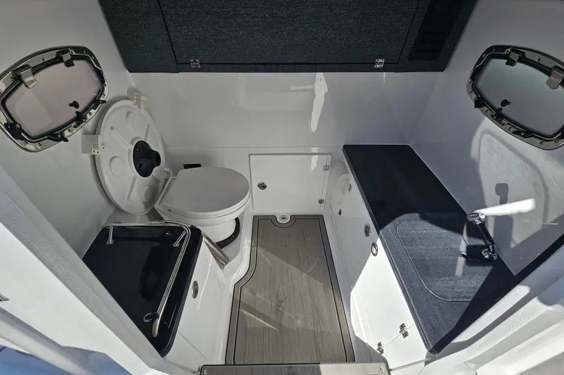 Slide: The Image of Interior of 2026 Monterey Elite 27 OB with toilet and seating area. - 27
