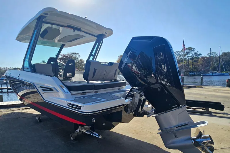 Slide: The Image of 2026 Monterey Elite 27 OB boat with powerful Mercury outboard engine, docked by the water. - 4