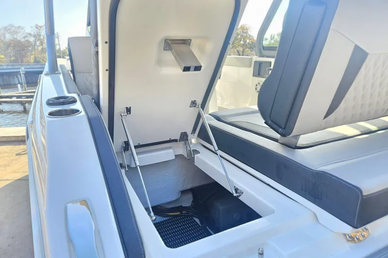 Slide: The Image of Open storage compartment on 2026 Monterey Elite 27 OB boat, showcasing interior features. - 7