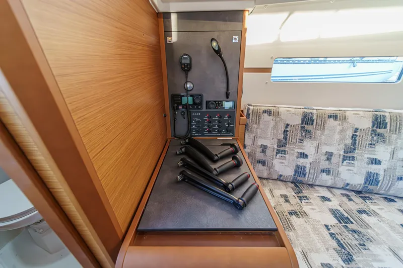 Slide: The Image of 2022 Jeanneau Sun Odyssey 349 interior with control panel and seating area. - 10