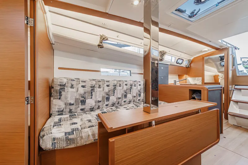 Slide: The Image of Interior of 2022 Jeanneau Sun Odyssey 349 sailboat, featuring modern seating and wooden finishes. - 13